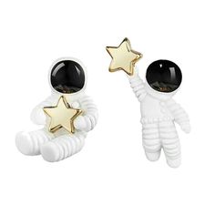 two white and gold earrings with stars on them