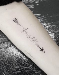 an arrow and bow tattoo on the right arm, with two arrows pointing towards each other