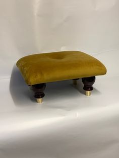 a footstool that is sitting on a white surface