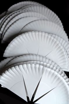 white paper plates are stacked on top of each other