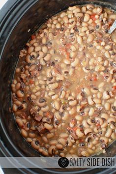 a slow cooker filled with beans and meat