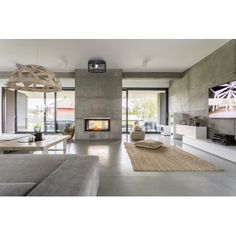 a modern living room with concrete walls and flooring