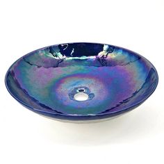 a blue and purple bowl shaped sink on a white surface