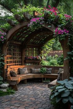 a wooden bench sitting under a lush green arbor