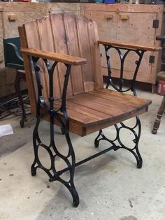 two wooden chairs sitting next to each other on top of a cement floor in a room