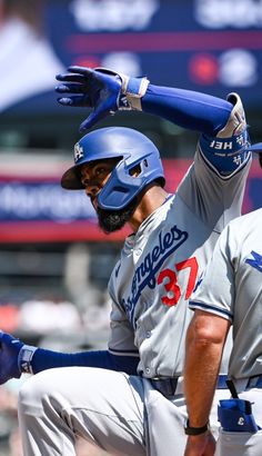 a baseball player holding his bat in the air