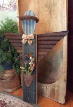 a potted plant sitting on top of a wooden shelf next to a metal bird