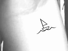 a black and white photo of a person's arm with a sailboat tattoo on it