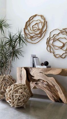 a wooden table sitting next to a potted plant