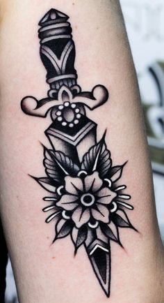 a black and white tattoo design on the arm