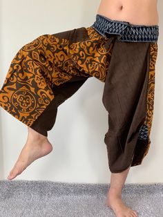 "* This is a unique product. The pants shown in the photo are the only pair in the world and will be sent to the buyer. These special design harem pants have fisherman pants style wrap around waist and belt, totally unlike anything before them. The main fabric is made from pre-washed soft cotton with subtle texture. The fold over waist is made from vintage handmade fabric brought from hill tribes in northern Thailand, so they are totally unique. There is one side pocket for your essentials. The Hippie Style Brown Harem Pants For Festival, Hippie Brown Harem Pants For Festival, Brown Harem Yoga Pants, Brown Harem Bottoms For Yoga, Brown Harem Pants For Yoga, Hippie Brown Harem Bottoms, Hippie Brown Harem Pants, Brown Hippie Harem Pants, Traditional Brown Harem Pants