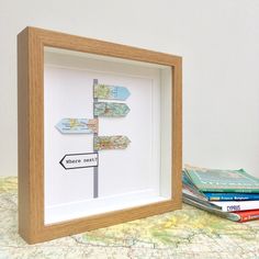 a wooden frame holding a map and some books