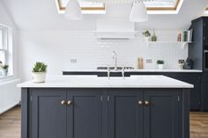 a kitchen with an island and skylights above it