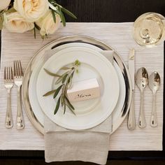 a place setting with flowers and silverware