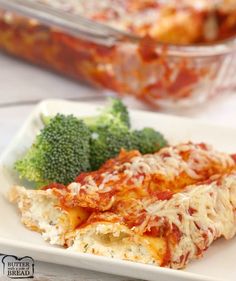 broccoli and lasagna casserole on a white plate with a glass dish in the background