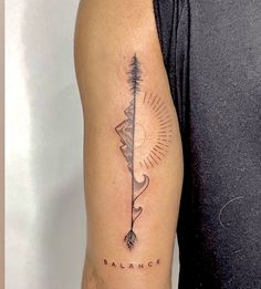 a man with a tattoo on his arm that has the word balance and an arrow