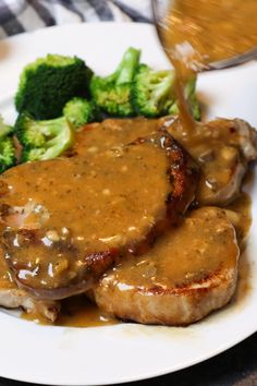 some meat with gravy and broccoli on a plate