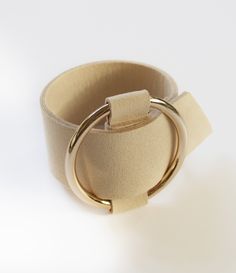 Statement cuffs are what it's about. We are totally swooning over our new microfiber cuff bracelet, so fabulous! Made from creamy colored microfiber with a large, ring shaped, gold buckle. You will receive two free gifts with purchase. Free shipping. Adjustable Gold Leather Chic Bracelet, Adjustable Gold Leather Bracelet Chic Style, Chic Adjustable Cream Jewelry, Gold Leather Cuff Bracelet, Chic Adjustable Cream Bracelets, Chic Adjustable Cream Bracelet, Chic Beige Wristlet Gift, Chic Beige Wristlet As A Gift, Chic Beige Wristlet For Gift