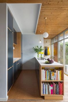 a kitchen with bookshelves and cabinets in it