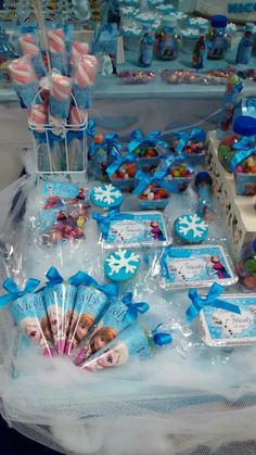 frozen princess themed birthday party with cupcakes, cookies and candies on display