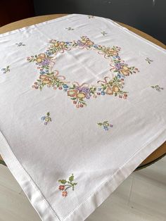 a white table cloth with colorful flowers on it