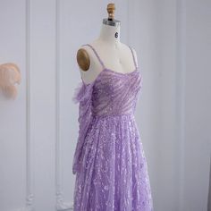 Luxurious Dubai Design: The dress embodies the opulence of Dubai's fashion scene, showcasing elegance and sophistication, making it a perfect choice for upscale events, particularly for wedding parties. Beaded Lilac Detailing: Adorned with intricate beading in a delightful lilac color, the dress exudes opulence and glamour, adding a touch of refinement and sparkle to your ensemble. Elegant Sage Green Long Sleeve Formal Gowns: The dress pairs ideally with sage green long sleeve formal gowns, creating a harmonious and stylish ensemble for any elegant affair. Women's Dress: Designed specifically for women, this dress celebrates femininity and elegance, ensuring you feel beautiful and sophisticated at every moment. High-Quality Craftsmanship: Meticulously crafted with attention to detail and u Floor-length Gown For Debutante Ball Gala, Purple Ball Gown For Banquet, Purple Gown With Sweetheart Neckline For Banquet, Gala Ball Gown For Debutante Ball, Gala Ball Gown Evening Dress For Debutante Ball, Tulle Gown For Wedding Gala, Tulle Gown For Wedding And Gala, Wedding Gala Tulle Gown, Fitted Gown For Debutante Ball Gala