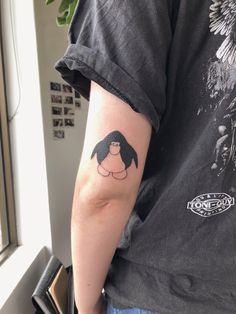 a person with a black and white tattoo on their arm