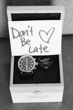 a black and white photo of a watch in a box that says don't be late