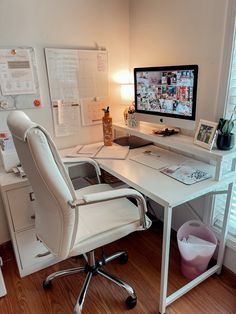 a white desk with a computer on it and a chair in front of the monitor