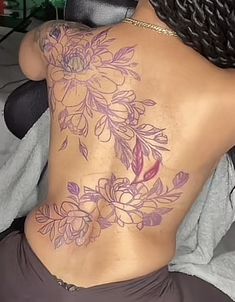 the back of a woman's body with flowers on it