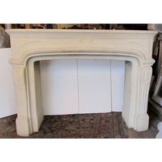 an old fireplace with white paint on the mantle