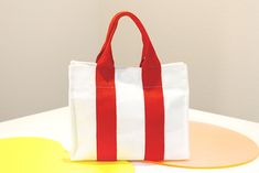 "It's a simple and comfortable tote bag. I wanted to show you this style of bag, I finally found it If you are looking for a bright, comfortable, and anywhere suitable bag! You should get it~ We have three colors: black, yellow, and red. As the weather gets warmer, red and yellow stand out. But you can use black easily. Overall, it's a small size, but you can use it comfortably because it contains all the belongings you normally use. It also includes a bag strap that can be tied to the side, so Daily Bag, Kids' Bag, Cross Bag, Personalized Photo Gifts, Personalized Embroidery, Work Bag, Womens Tote, Personalize Bag, Bag Tags