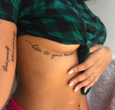 a woman's stomach with tattoos on it and the words, love is your heart