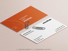 business card mockup with pen and paperclip on the front, orange background