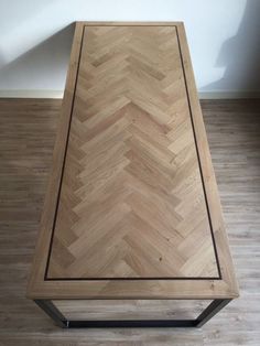 a wooden table sitting on top of a hard wood floor