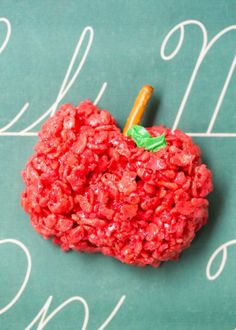 an apple made out of cereal on top of a chalkboard