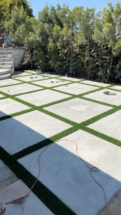 an outdoor patio with artificial grass and steps