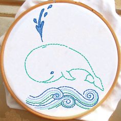 an embroidery project with a blue whale on it