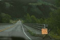 an empty road with a sign on the side