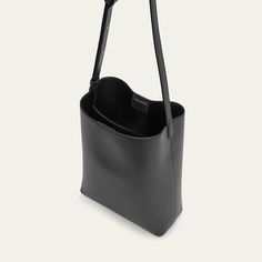 Aesther Ekme bucket bag in smooth calfskin leather  Adjustable shoulder strap  Open top with magnetic closure  Center slip compartment divides interior  Approx. 17.3"H x 7.6"W x 4.5"D Made in Spain Open Top, Magnetic Closure, Bucket Bag, Calf Skin, Shoulder Strap, Tops Designs, Spain, Luxury Fashion, Leather