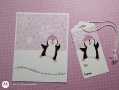 two tags with penguins and snowflakes on them