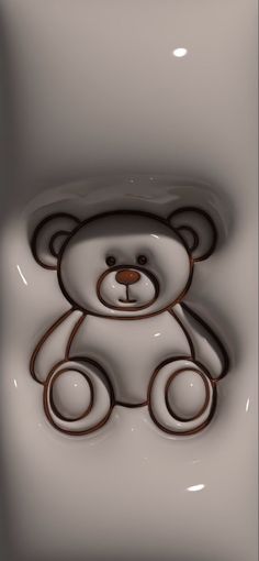 a brown teddy bear sitting on top of a white floor