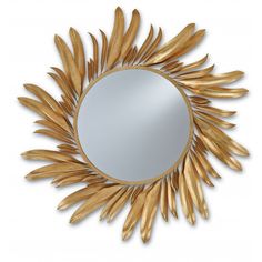 a mirror that is sitting on top of a white surface with gold leaf decorations around it