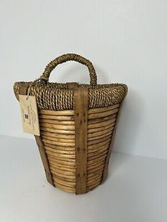 a small wicker basket with a tag on it