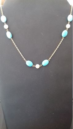 Fancy, original, handmade necklace for women and girls. This necklace is made up of a very pretty chain on which, at the drop of the necklace, turquoise pearls separated by a white mother-of-pearl pearl have been attached. There are three sets of turquoise and pearly pearl. This necklace, with its lightness and elegance, is ideal to be offered or worn for occasions or celebrations such as: Christmas, New Year's Day, Valentine's Day, Birthday, Mother's Day, etc.... .. Turquoise Pearl Necklace With Pearl Drop, Turquoise Necklace With Pearl Drop For Gift, Turquoise Necklace With Pearl Drop As Gift, Elegant Turquoise Pearl Necklace, Turquoise Necklace With Pearl Pendant For Gift, Turquoise Pearl Necklaces With Pearl Charm, Gift Turquoise Necklaces With Pearl Chain, Elegant Turquoise Pearl Drop Necklace, Elegant Turquoise Chain Necklace Gift