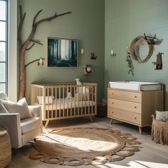 a baby's room with green walls and furniture