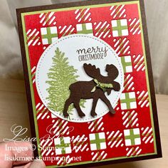 someone holding up a christmas card with a moose on it