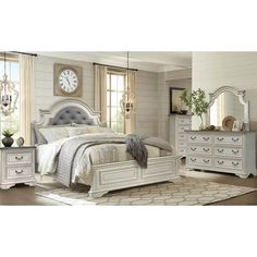 a bedroom with white furniture and a large clock on the wall above the headboard