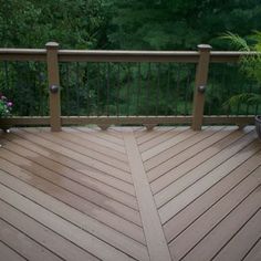 a wooden deck with potted plants on it