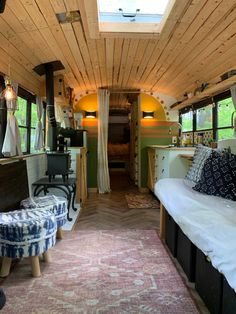 the inside of a bus with lots of furniture and decor on it's walls